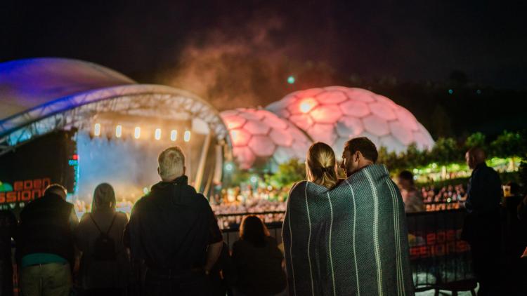 Couple wrapped in a blanket watching the Eden Sessions