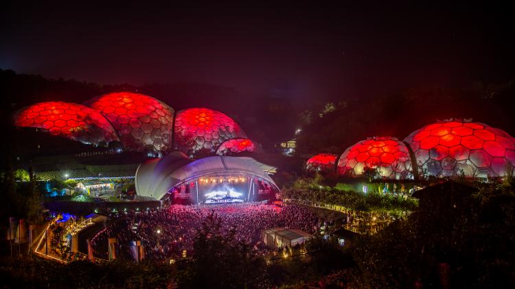 Wide view of an Eden Sessions concert with Biomes lit up red